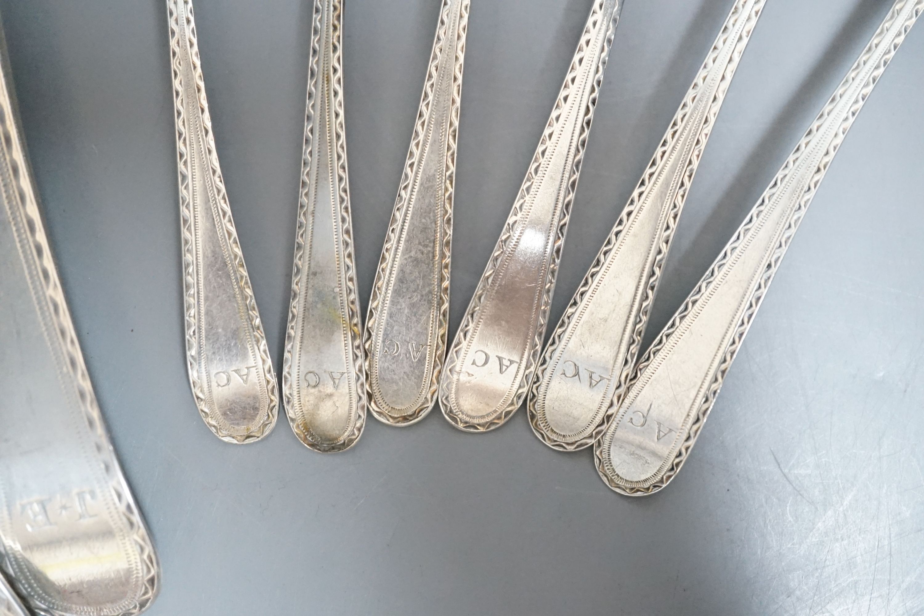 A set of silver George III bright cut engraved silver Old English pattern teaspoons, by Hester Bateman, no date letter and a pair of George III silver bright cut engraved Old English tablespoons, London, 1787
